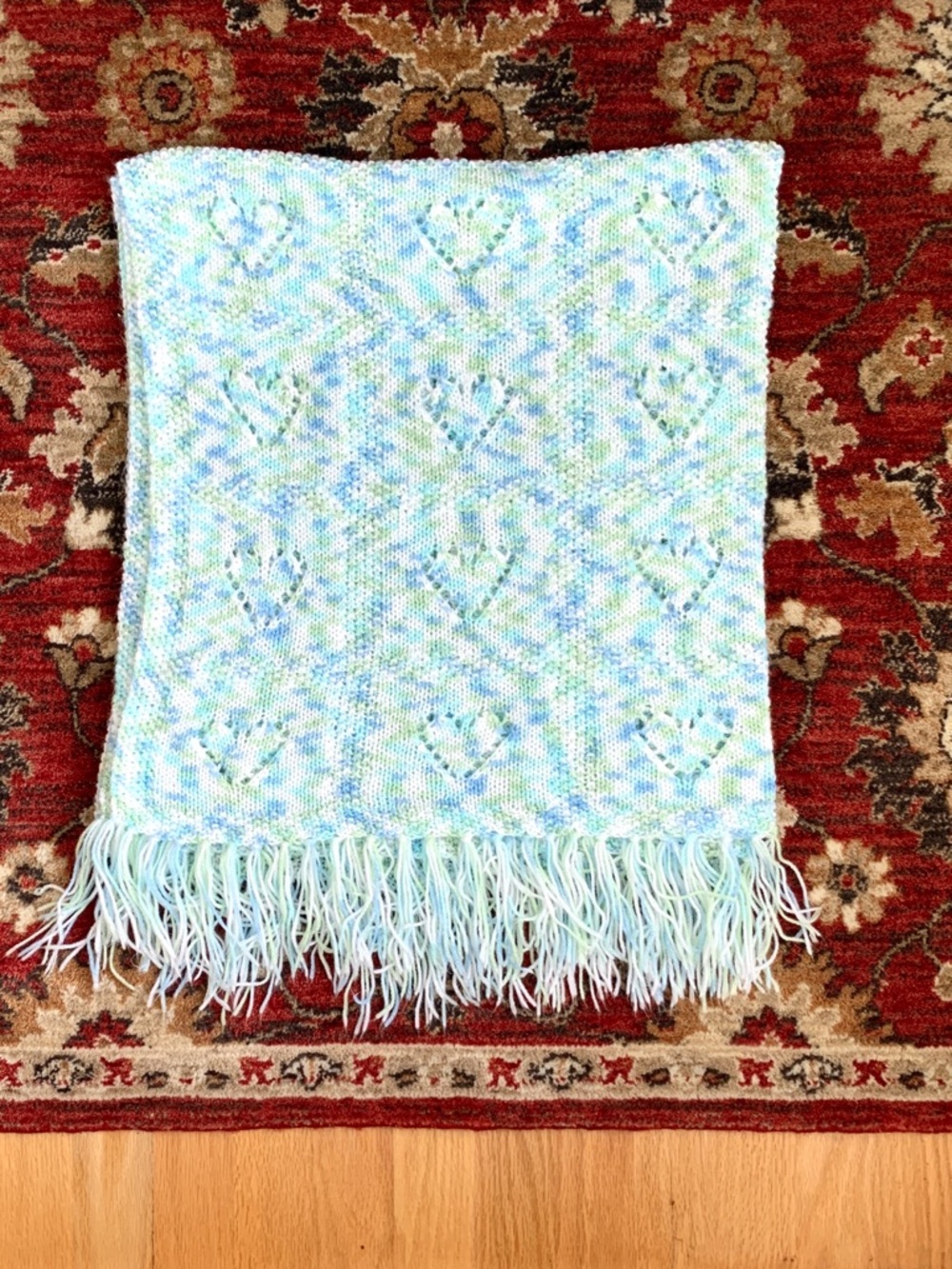 handmade white blue green crochet baby blanket with heart design